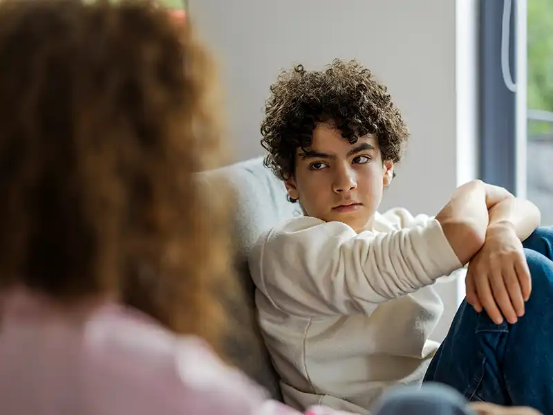 A young person talking to an adult