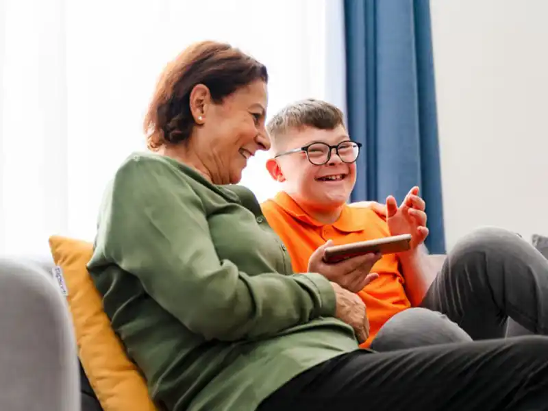 Patient and carer sat together on a sofa