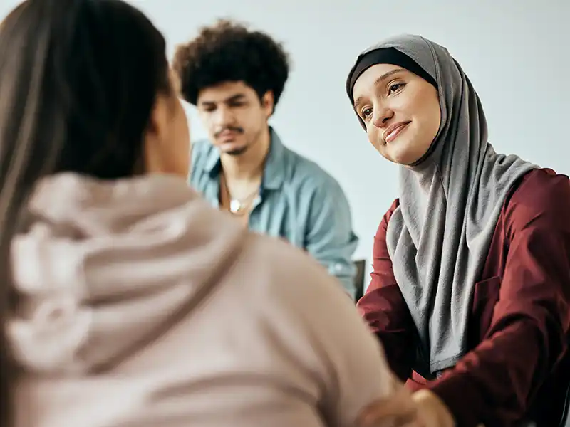 A young person and an adult talking