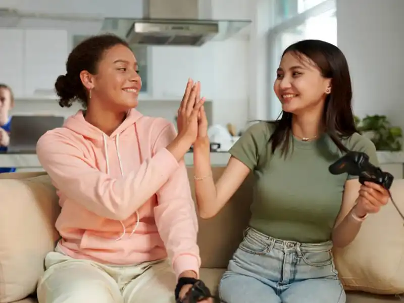 Two young people celebrating after gaming together